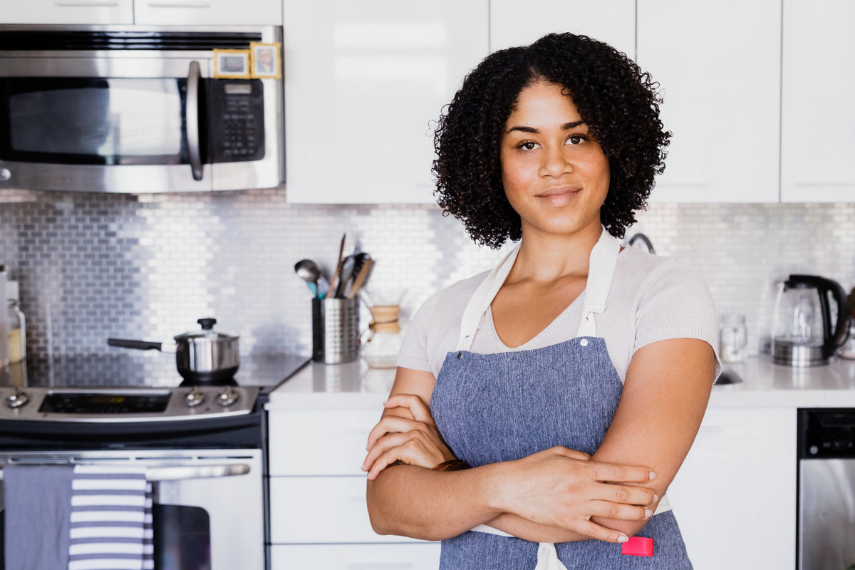 A welcoming home kitchen with an apron-clad cook