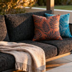 Elegantly designed patio with layered, high-performance textiles in charcoal and terracotta, evoking a strong narrative and purpose for outdoor comfort.